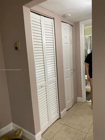 a view of hallway with stairs and a window