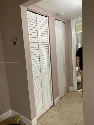 a view of hallway with stairs and a window