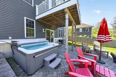 a backyard of a house with table and chairs