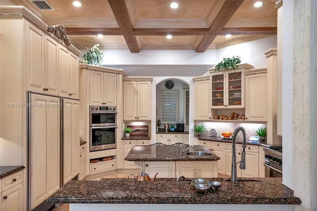 a living room with stainless steel appliances granite countertop furniture and a rug