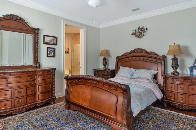 a bedroom with a bed and a dresser
