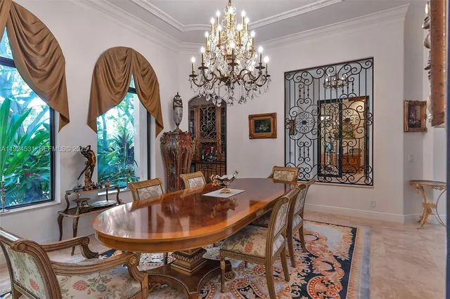 a dining room with furniture a chandelier and window