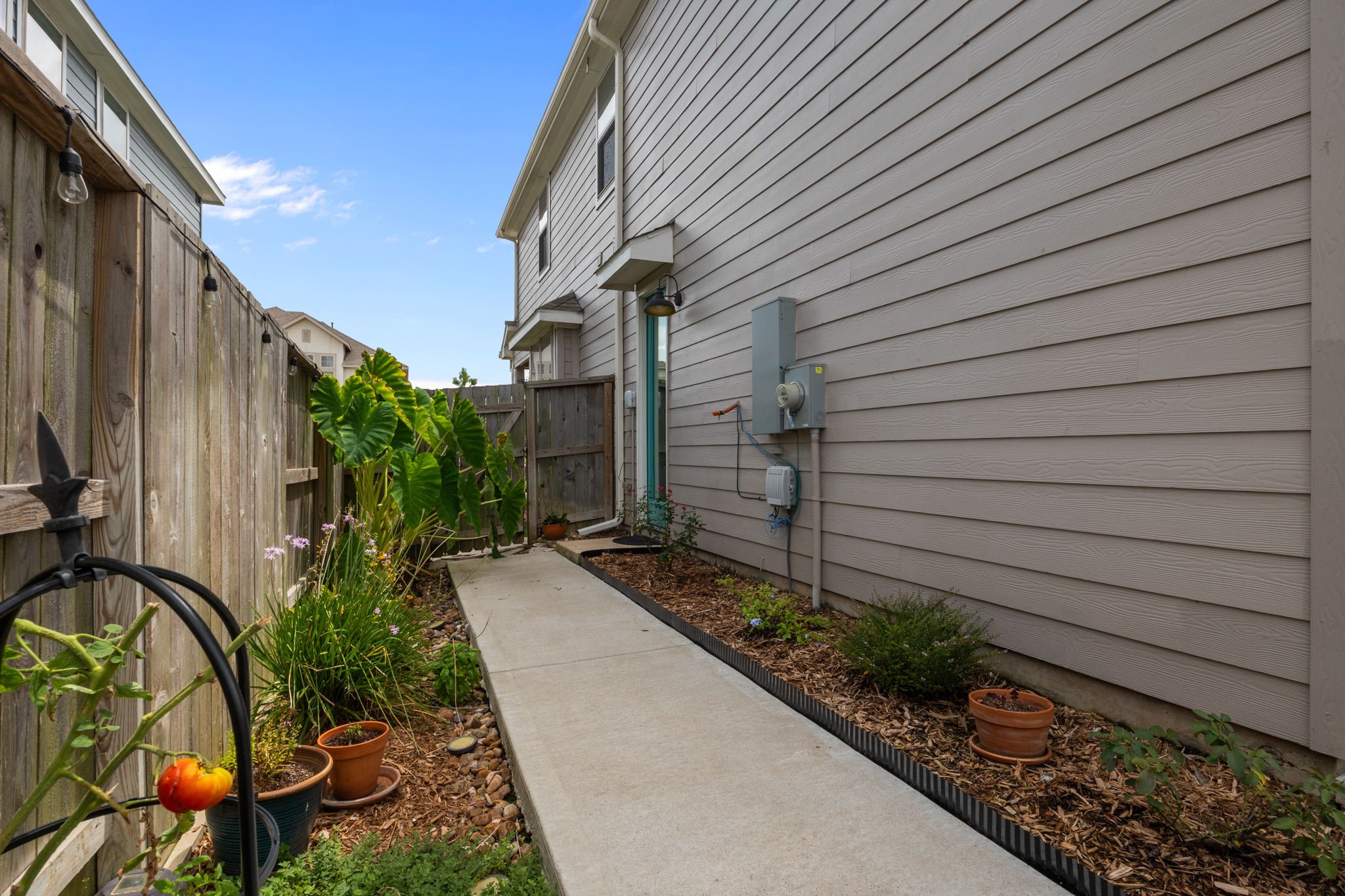4063 Champlain Way Iowa Colony, TX 77583 - Photo 29 of 45 House has gutters all the way around. Gorgeous landscaped sideyard