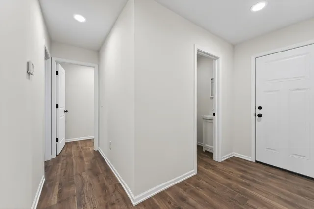 a view of hallway with wooden floor