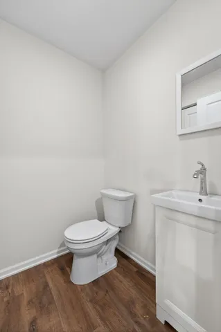 a white toilet sitting next to a bathroom sink