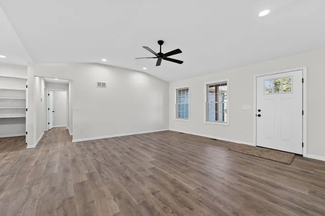 wooden floor in an empty room with a window