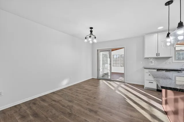 a view of an empty room with a kitchen