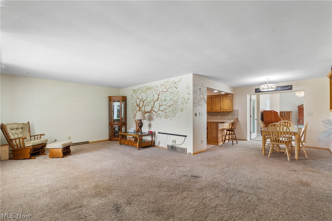 22840 Buck Road Alliance, OH 44601 - Photo 4 of 36 Living area featuring light carpet and a chandelier