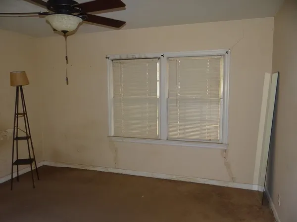 an empty room with wooden floor and closet