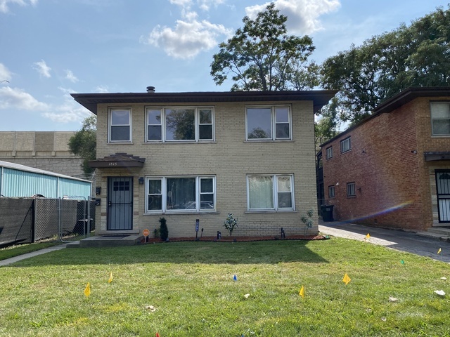 1815 171st Street Hazel Crest, IL 60429 - Photo 1 of 18 a front view of a house with a garden