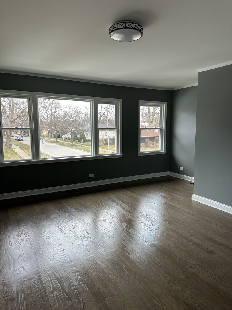 1815 171st Street Hazel Crest, IL 60429 - Photo 3 of 18 an empty room with wooden floor and windows