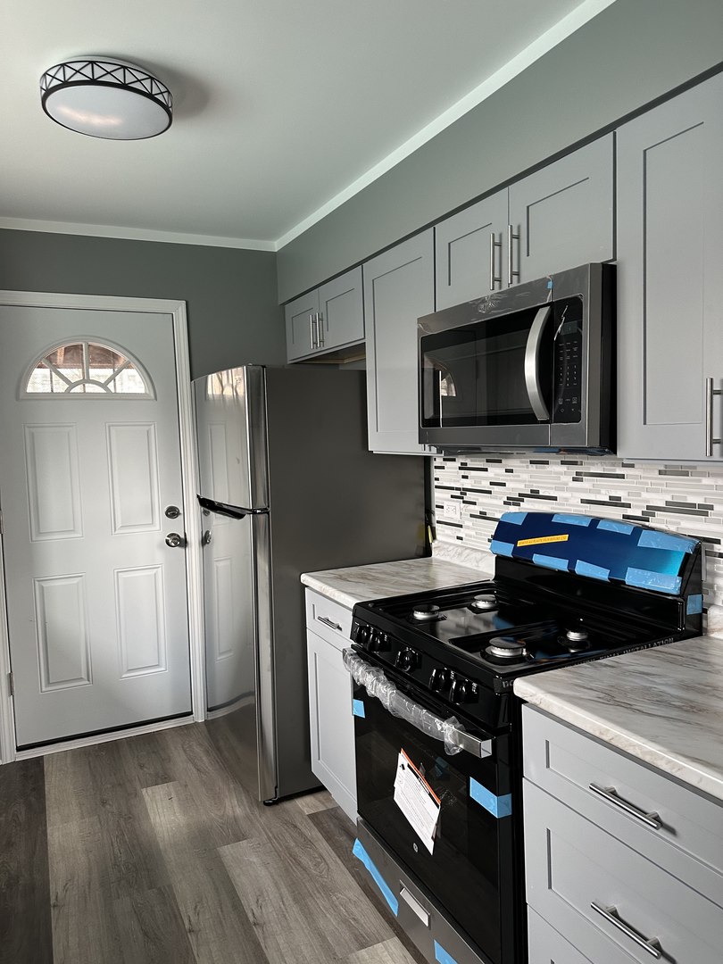1815 171st Street Hazel Crest, IL 60429 - Photo 9 of 18 a kitchen with a stove and a microwave