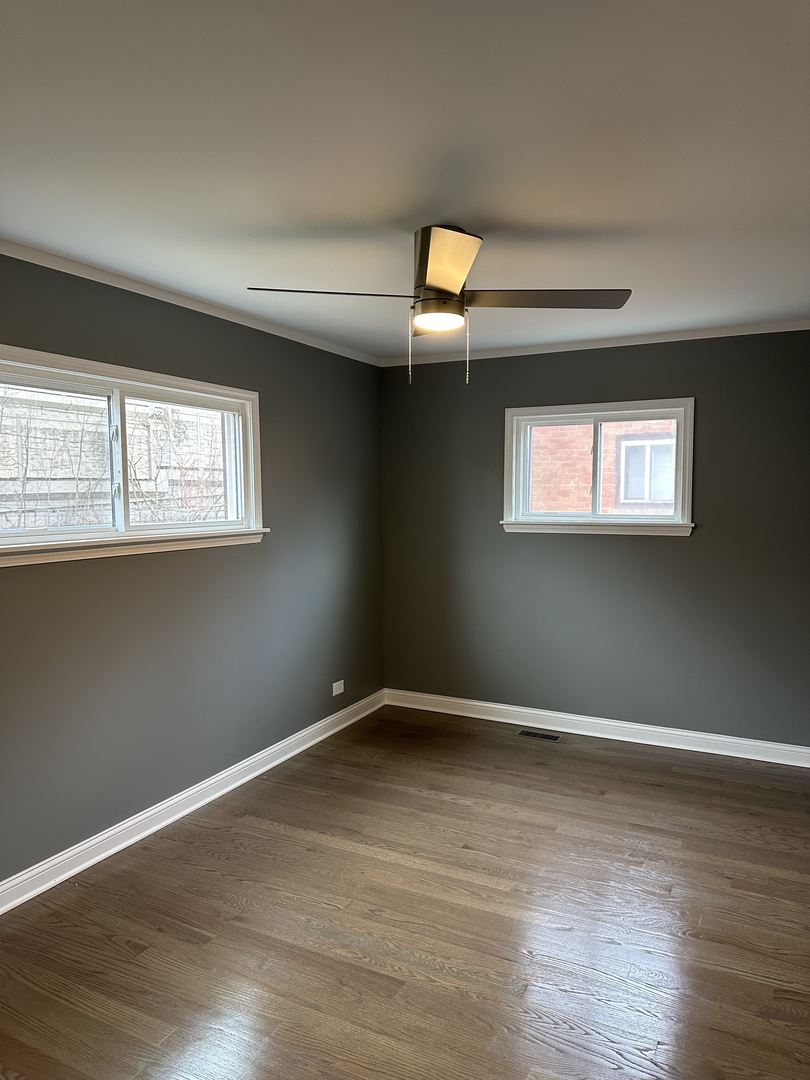 1815 171st Street Hazel Crest, IL 60429 - Photo 10 of 18 a view of an empty room with wooden floor and a window