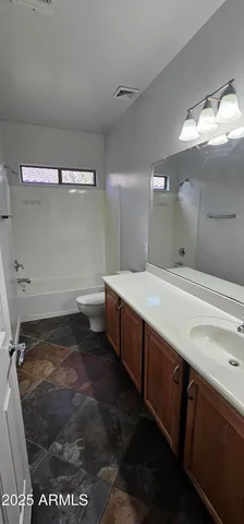 a bathroom with a double vanity sink and mirror