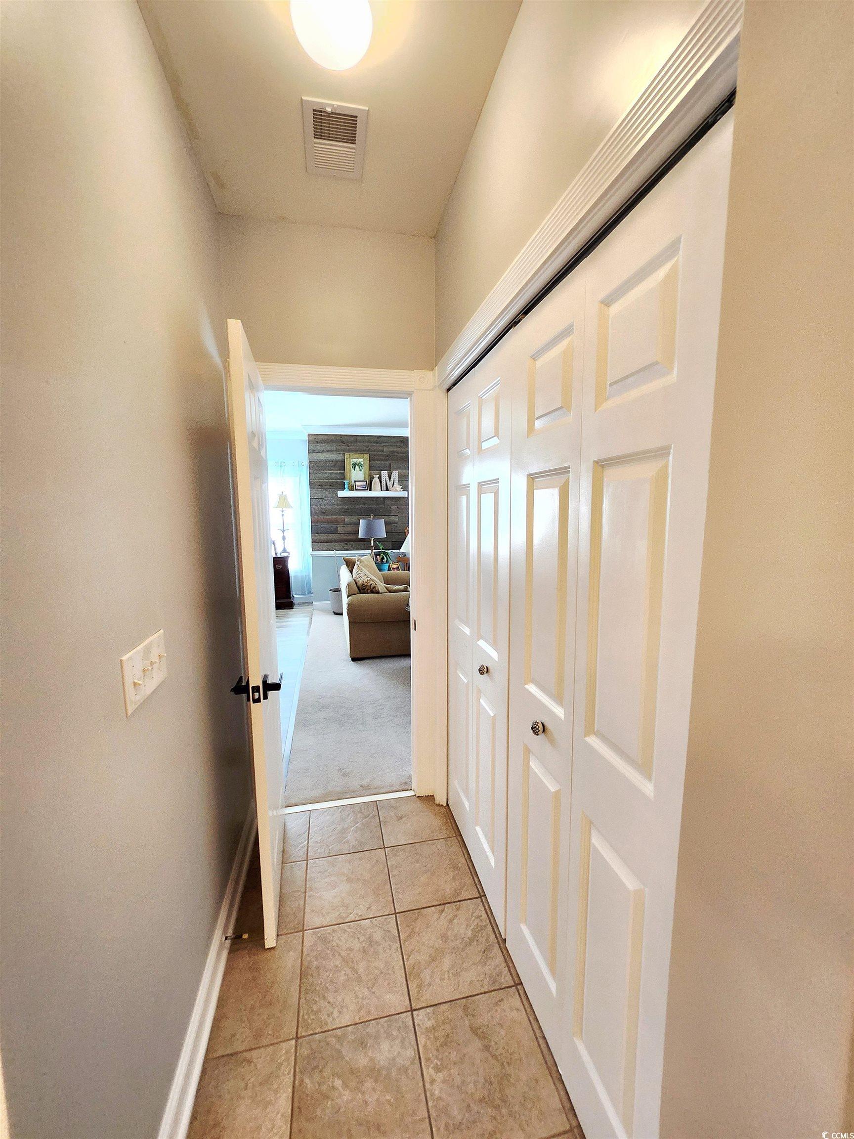 4877 Magnolia Pointe Lane, Unit 201 Myrtle Beach, SC 29577 - Photo 11 of 22 Hall with light tile patterned flooring and light carpet