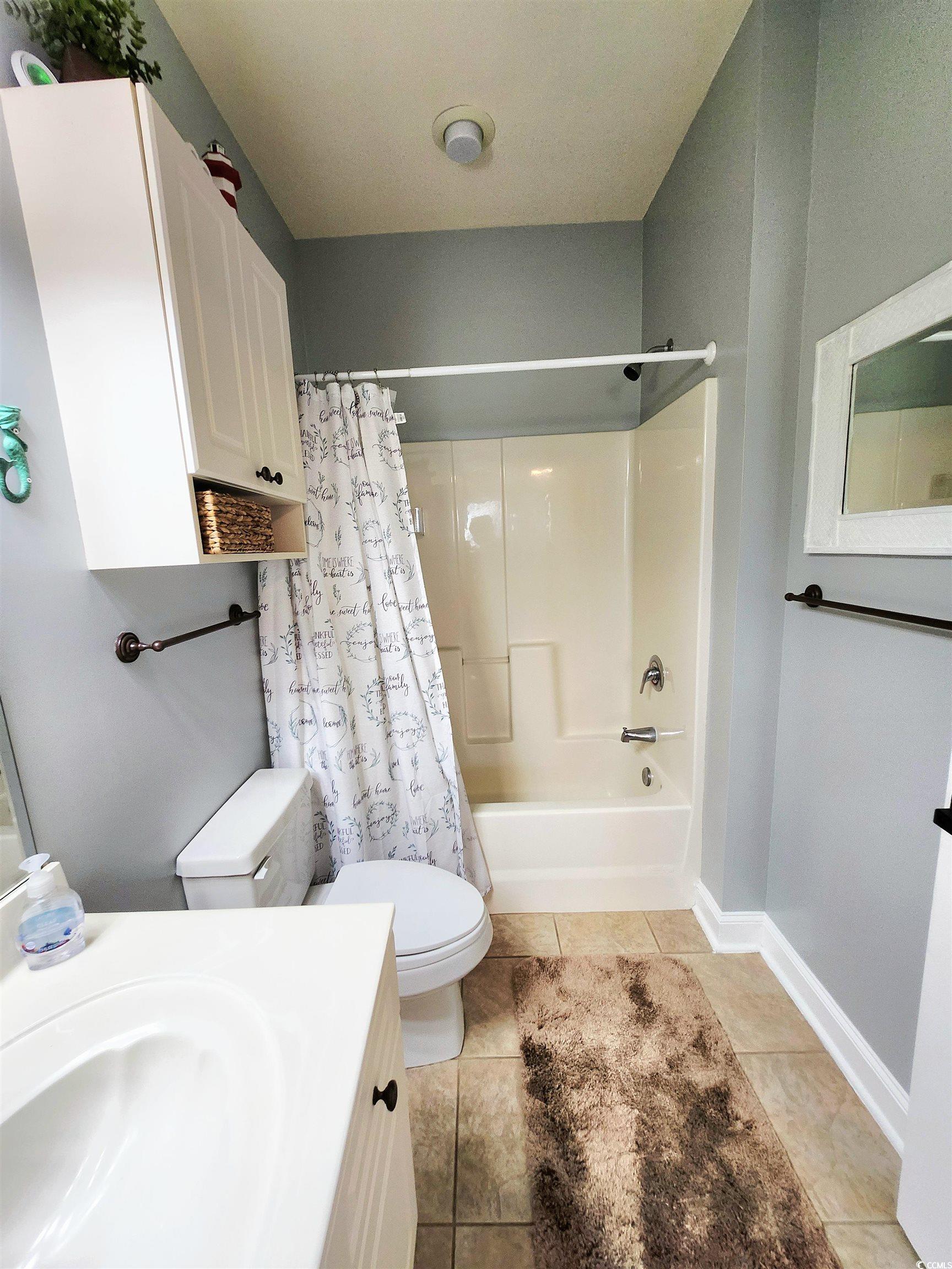 4877 Magnolia Pointe Lane, Unit 201 Myrtle Beach, SC 29577 - Photo 13 of 22 Full bathroom with shower / tub combo with curtain, vanity, and light tile patterned flooring