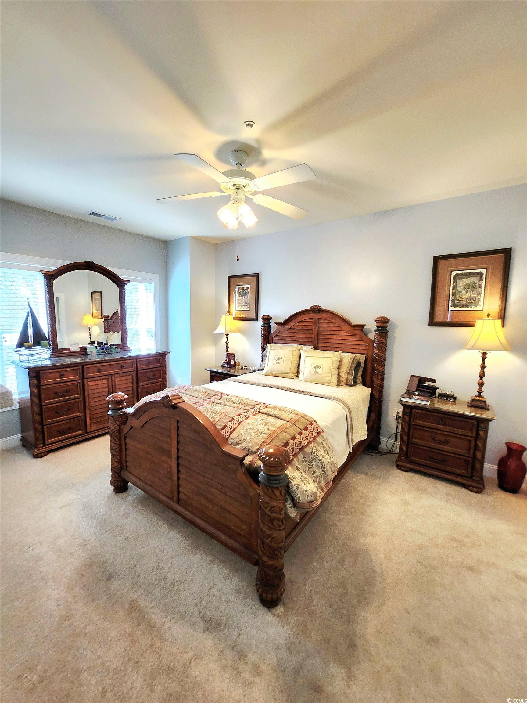 4877 Magnolia Pointe Lane, Unit 201 Myrtle Beach, SC 29577 - Photo 15 of 22 Bedroom featuring light carpet and ceiling fan