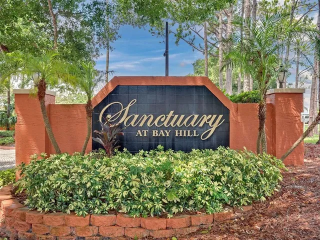 a view of a sign board with wooden fence
