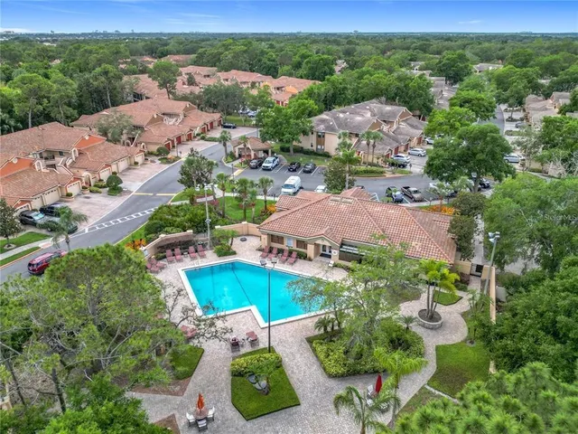 an aerial view of residential houses with outdoor space and street view