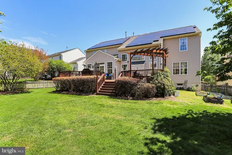 a view of backyard of house with green space