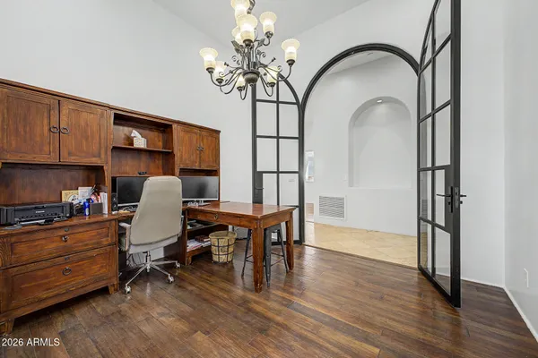 a view of a workspace with furniture and wooden floor