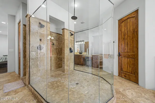 a bathroom with a glass shower door and a glass door