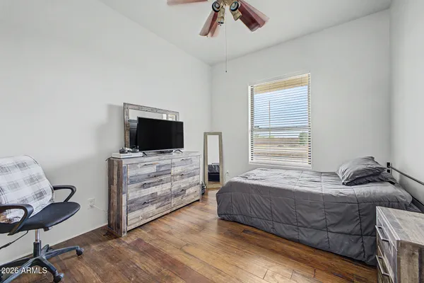 a bedroom with a bed and flat screen tv
