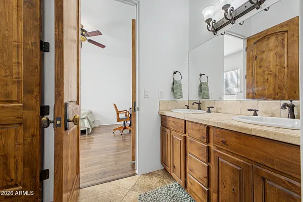 a bathroom with a double vanity sink a mirror and shower