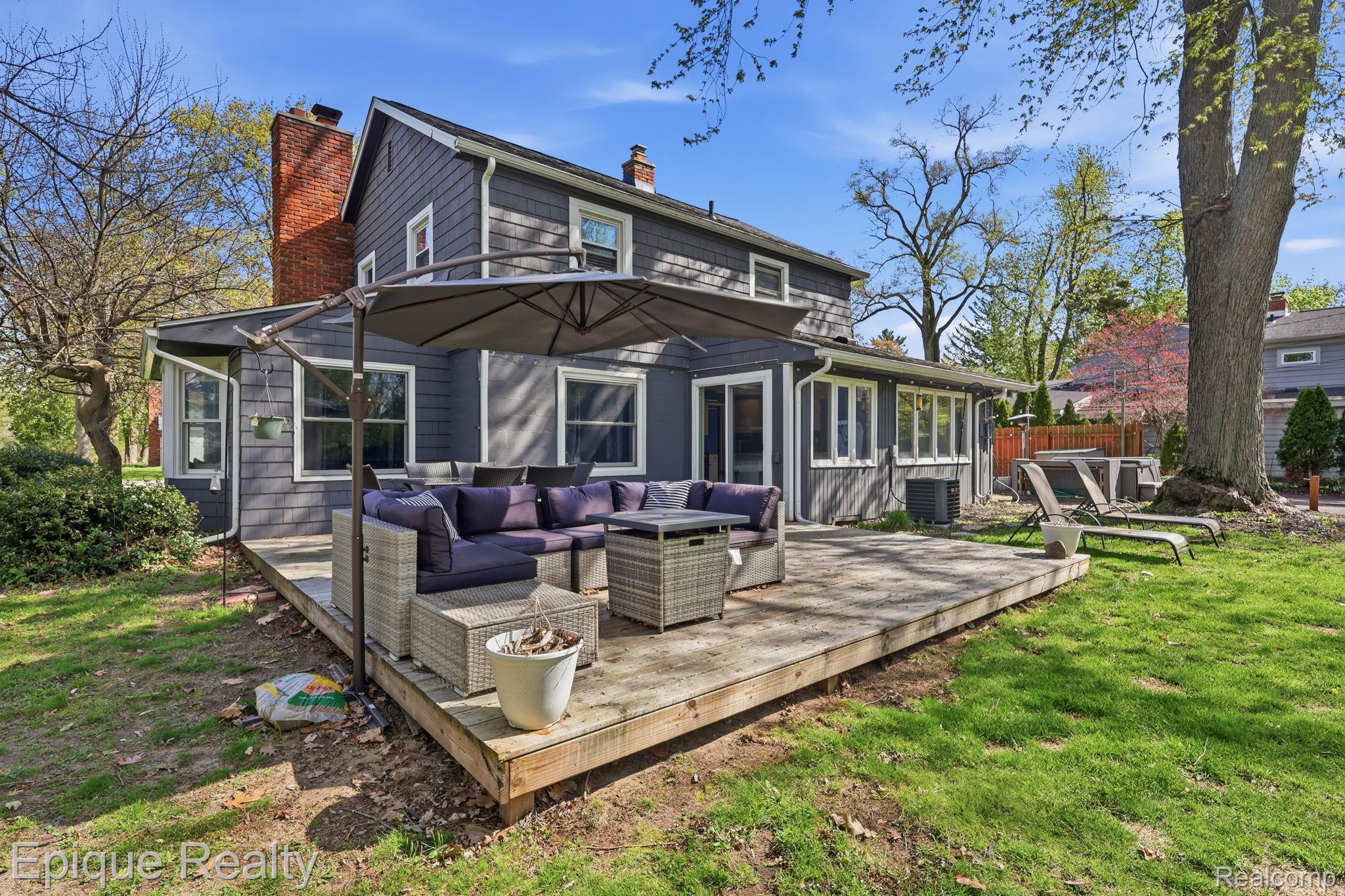 7441 Honeysuckle Road West Bloomfield, MI 48324 - Photo 26 of 35 Rear view of property with a chimney, outdoor lounge area, and a wooden deck