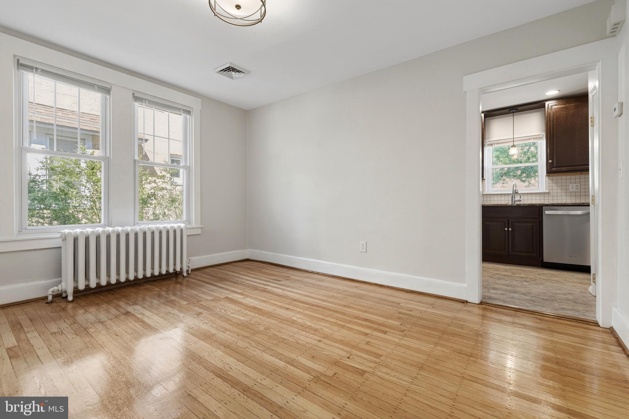 229 Wayne Avenue Narberth, PA 19072 - Photo 12 of 35 an empty room with wooden floor and windows