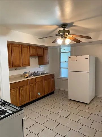 a kitchen with a refrigerator sink and cabinets