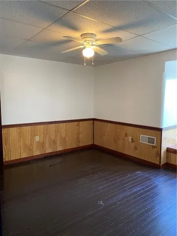 a view of an empty room and wooden floor