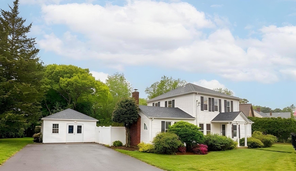 114 Curve Street Dedham, MA 02026 - Photo 3 of 27 a front view of a house with a yard and garage