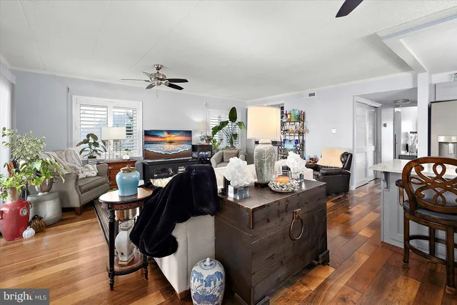 a living room with furniture a window and a chandelier