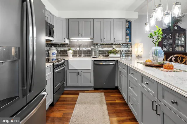 a kitchen with stainless steel appliances granite countertop a refrigerator sink and cabinets