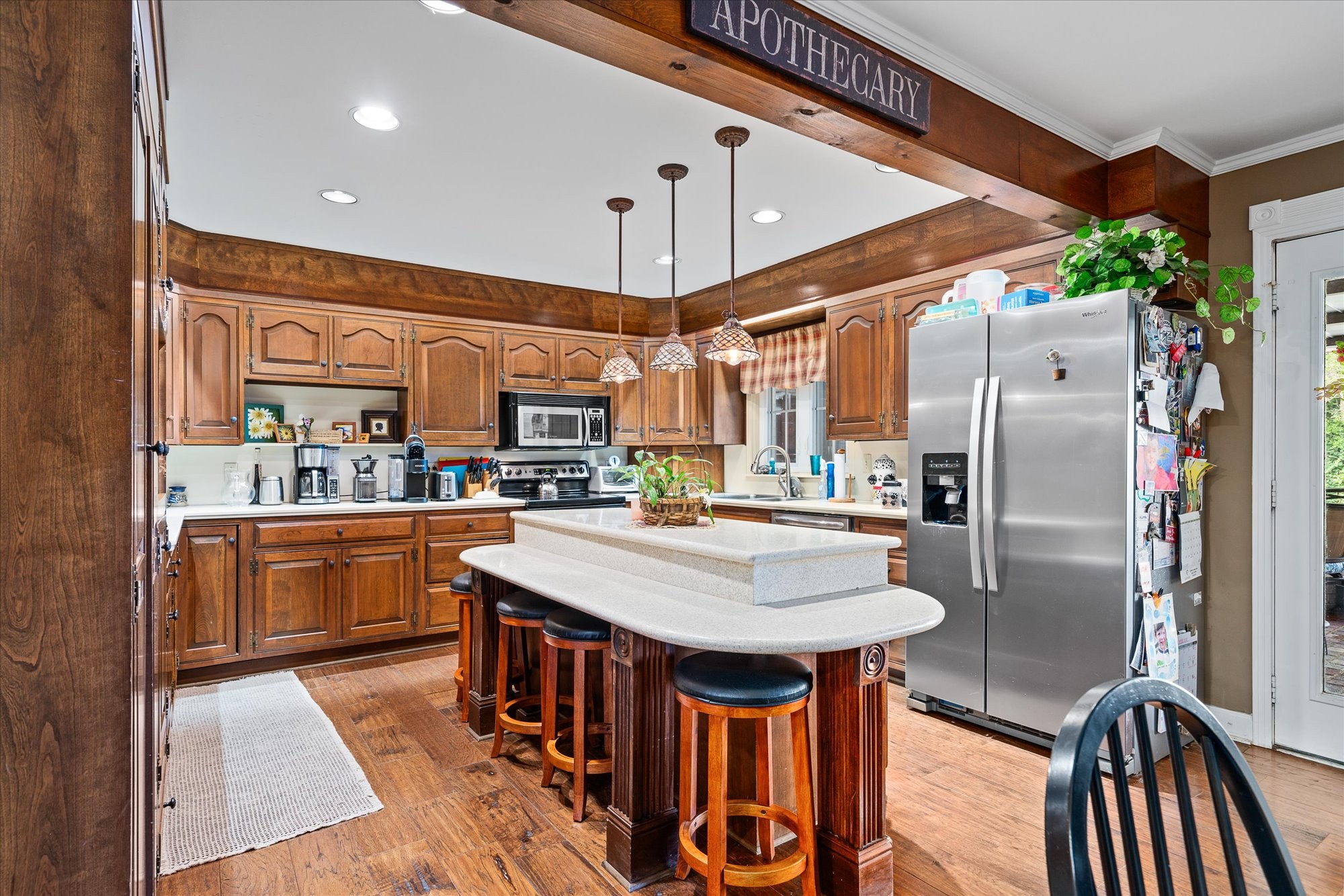 548 Turntable Road Sparta, TN 38583 - Photo 12 of 51 a kitchen with stainless steel appliances granite countertop a sink a stove a refrigerator cabinets and chairs