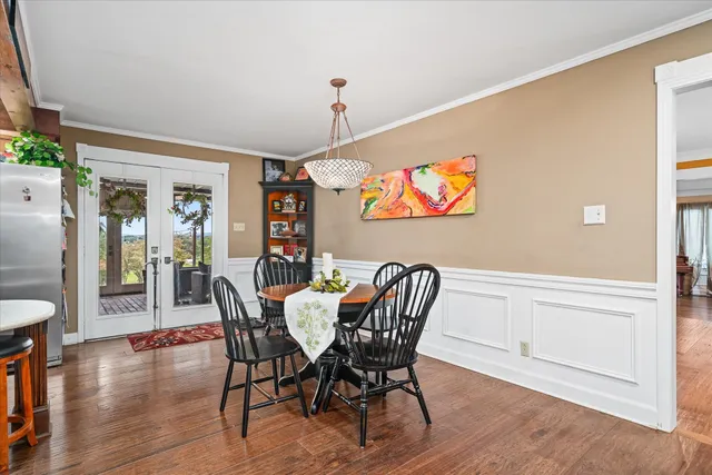 a view of a dining room with furniture wooden floor and chandelier