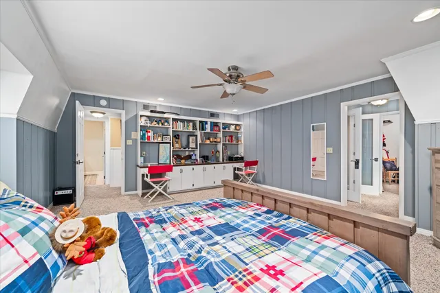 a living room with baby crib furniture and a wooden floor
