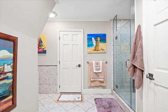 a view of an entryway with bathroom and mirror