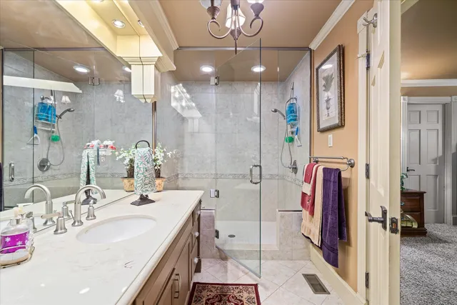 a bathroom with a double vanity sink mirror and shower