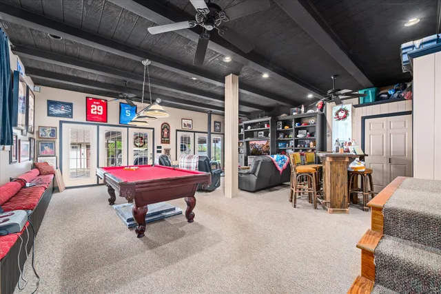 a living room with furniture a flat screen tv and a table