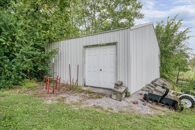 a backyard of a house with table and chairs