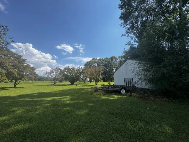 a backyard of a house with table and chairs