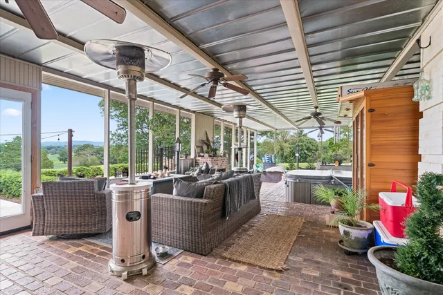 a living room with patio furniture and garden view