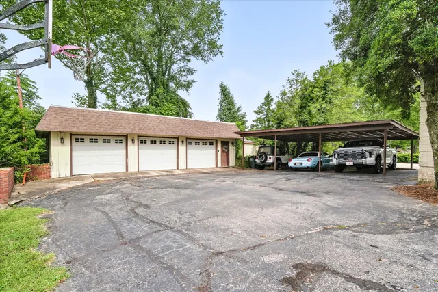 a view of a house with a garden and trees