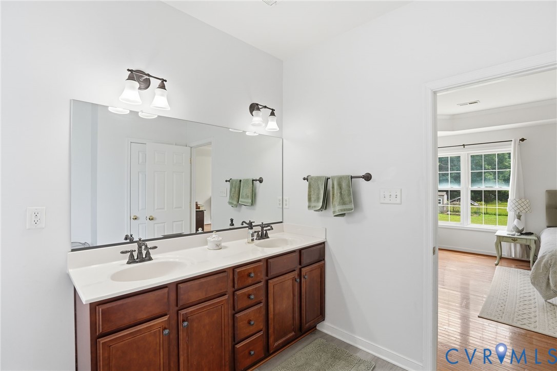 5305 Wellington Ridge Road Richmond, VA 23231 - Photo 36 of 67 Double vanity with dark wood cabinetry, white coun