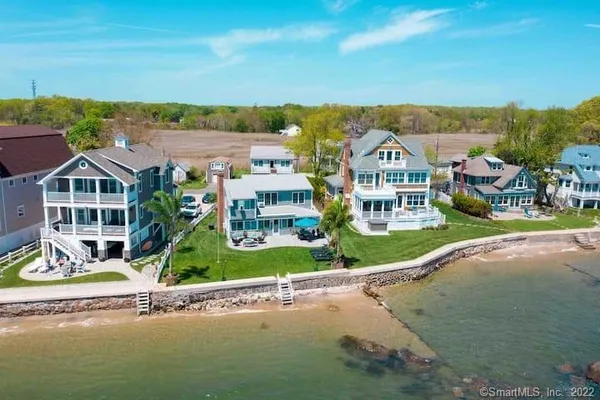 an aerial view of a house with a garden and lake view
