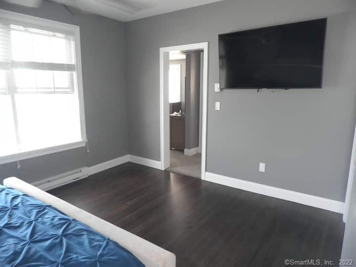 21 Grove Way, Unit 21 Clinton, CT 06413 - Photo 16 of 37 a view of a livingroom with wooden floor and a flat screen tv