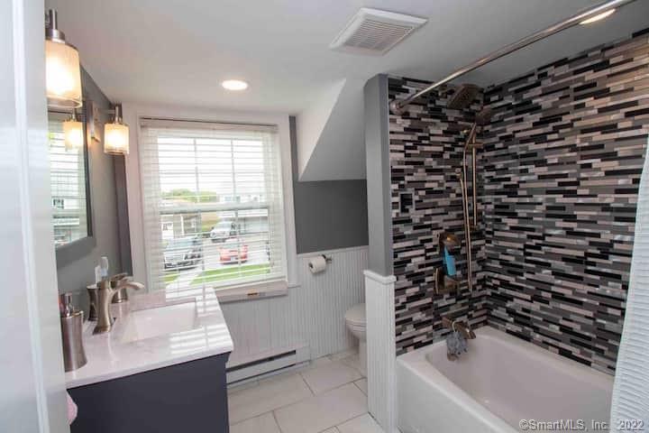 21 Grove Way, Unit 21 Clinton, CT 06413 - Photo 16 of 37 a bathroom with a bathtub a sink and a shower