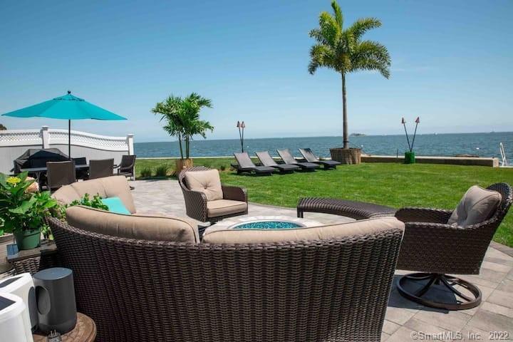 21 Grove Way, Unit 21 Clinton, CT 06413 - Photo 18 of 37 a view of a patio with couches under an umbrella